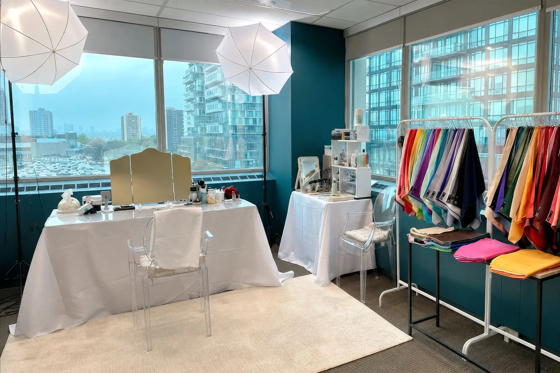 A office featuring a table cluttered with various clothes, showcasing a casual and work-in atmosphere.